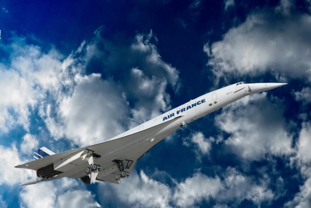 large white plane with blue sky and clouds