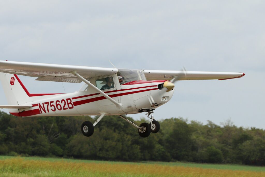 White and red plane with trees in the background