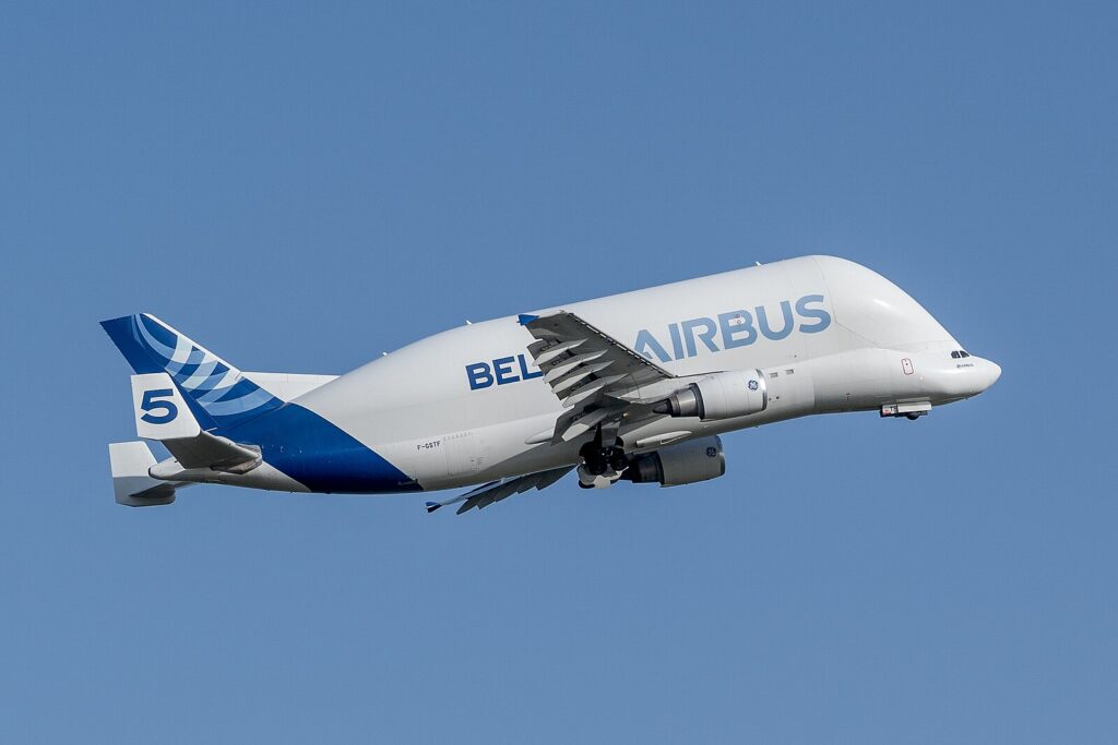 white and blue plane with a blue sky