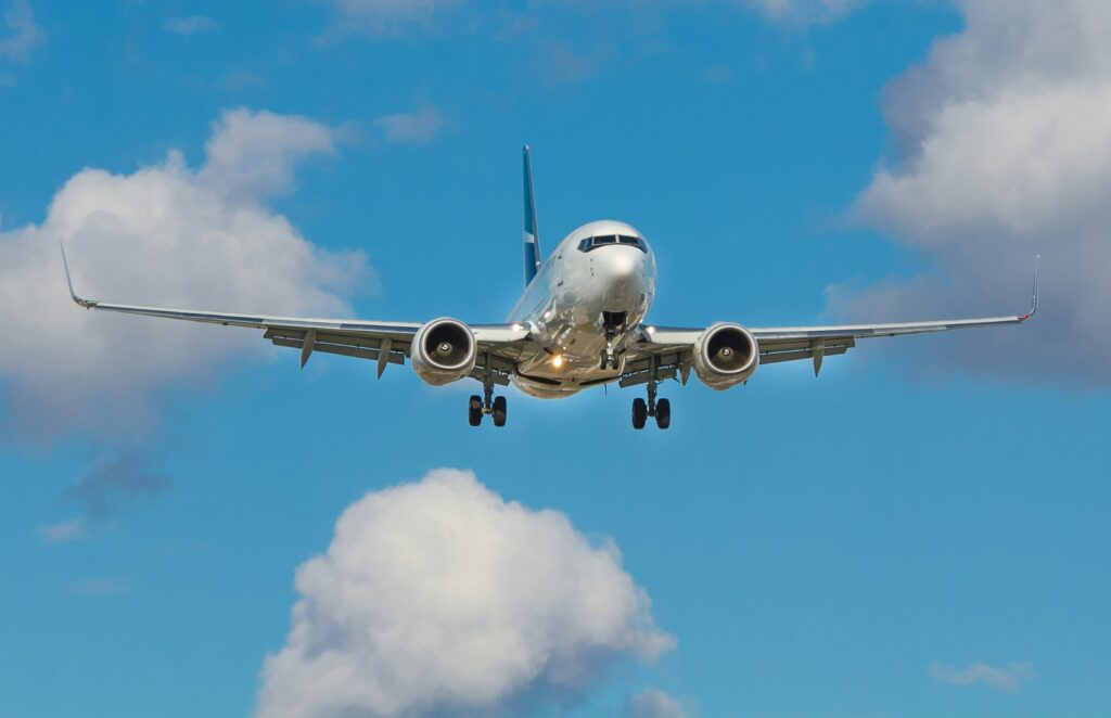 airplane with blue skies and white clouds