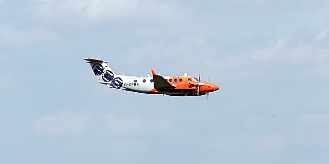 white and red plane in the sky