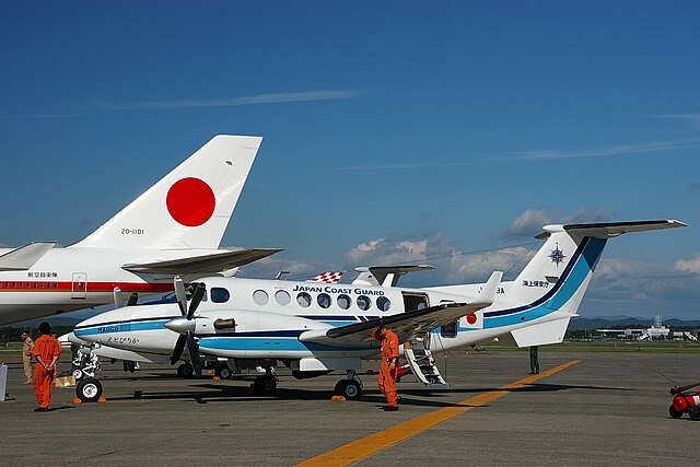 white and blue plane on tarmack